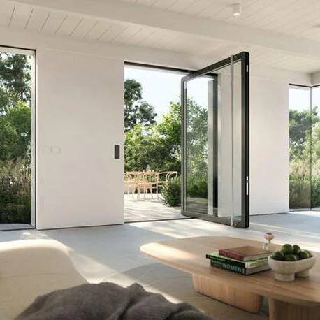 Interior with a large AD AL 75 pivot door standing open to the garden