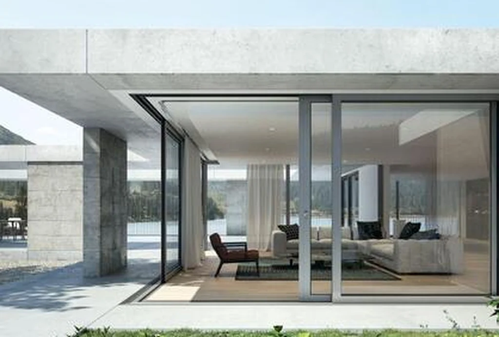 Single-storey house with Schüco lift-and-slide doors opening to a lawn