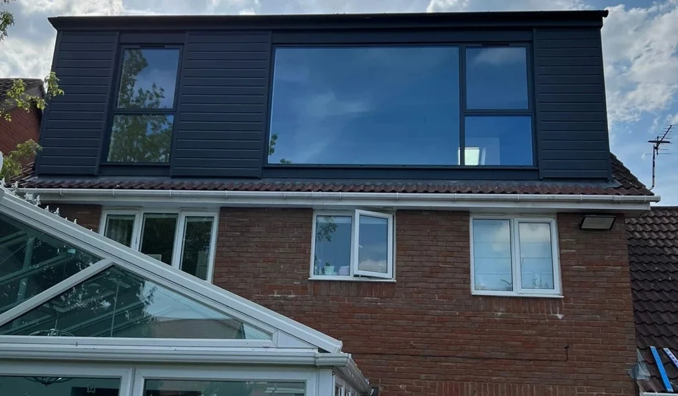 Installed AWS 80 SC windows in a dark finish on a dormer extension