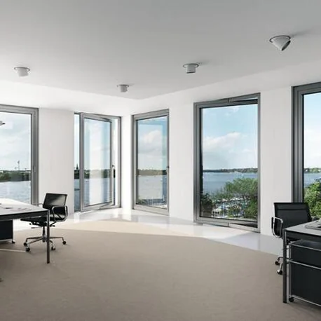 Waterfront office interior with AWS 90.SI+ windows across the elevation