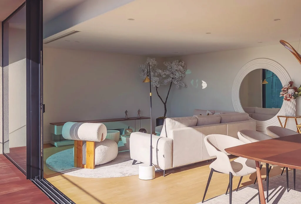 Edifício GUL, Aveiro — a living interior opening to the balcony through a Sosoares JT sliding wall